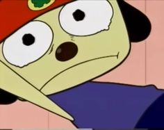 a cartoon dog wearing a red hat and looking at the camera with eyes wide open