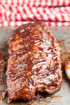 barbecue ribs covered in bbq sauce on a baking sheet