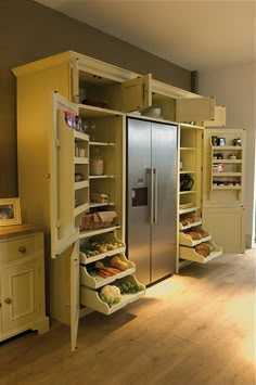 an open refrigerator in the middle of a kitchen