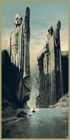 two large statues standing next to each other on top of a cliff near the ocean