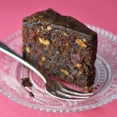 a close up of a piece of cake on a plate with a fork in it