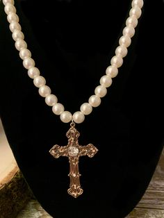 Gorgeous faux pearl necklace with golden rhinestone cross. Perfect for renaissance fairs, Halloween, or other occasions. Elegant Pearl Crucifix Necklace, Elegant Crucifix Pearl Necklace, Elegant Gold Cross Necklace With Pearl Pendant, Gold Cross Necklace With Pearl Chain, Pearl Drop Cross Necklace, Pearl Chain Cross Necklace, Gold Cross Necklace With Pearl Charm, Gold Pearl Crucifix Jewelry, Elegant Cross Necklace With Pearl Drop