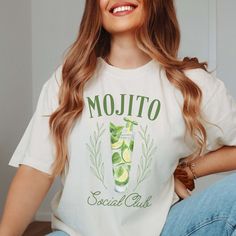 Indulge in the laid-back vibes of summer with our Mojito Social Club Comfort Color Tee, a refreshing addition to any casual wardrobe. Crafted from premium Comfort Color fabric, this tee offers unbeatable softness and comfort, ensuring you stay cool and relaxed all day long. The Mojito Social Club design brings a touch of tropical flair, featuring a cool mojito glass adorned with mint leaves. Whether you're lounging beachside or enjoying a night out with friends, this tee adds a splash of fun to Summer Graphic Print T-shirt For Brunch, Summer Graphic Tee For Brunch, Summer Brunch Cotton T-shirt, Summer Cotton T-shirt For Brunch, Cotton T-shirt For Summer Brunch, Trendy Summer T-shirt For Brunch, Casual Short Sleeve T-shirt For Brunch, Green T-shirt For A Summer Day Out, Green T-shirt For Summer Day Out