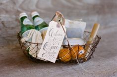 a basket filled with lots of different types of items next to a sign that says welcome