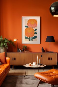 an orange living room with modern furniture and art work on the wall, along with candles