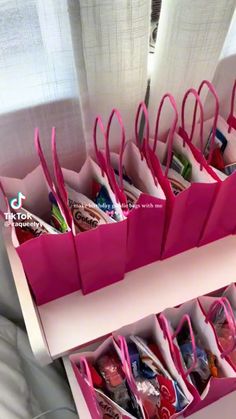 pink paper bags with handles are in a drawer