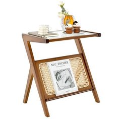 a wooden table with a magazine rack on it and a glass vase next to it