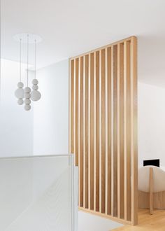 a room with wooden slats and white walls