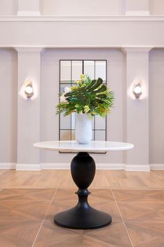 a white table with a potted plant on it