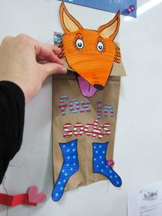 a paper bag with an image of a fox sticking out of it's mouth