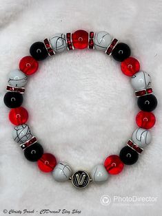 This elastic bead bracelet was made by hand & inspired by V!  It features glass beads, red rhinestone spacer beads, & alloy enamel alphabet beads. 8mm Glass Beads: ~ Marbled white/black ~ Red translucent ~ Black solid Please note: ~ I use quality elastic when making the bracelets, but the elastic can still break if overstretched. ~ Sizing Guide: Refer to posted image for more information on 2 sizes available Black And Red Beaded Bracelets, Red Glass Beaded Bracelets With Round Beads, Red Black White Beaded Bracelet, Hand-strung Red Beaded Bracelets As Gift, Red And Black Bracelets, Unique Hand-strung Red Beaded Bracelets, Ga Bulldogs, Alphabet Beads, Beads Bracelet Design