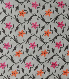 an orange and pink flowered design on white fabric