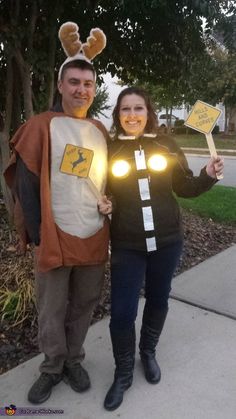 a man and woman dressed up in costumes standing next to each other on the sidewalk