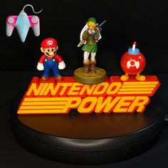 the nintendo power logo is displayed on top of a toy figure set with other figurines