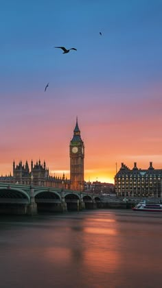 the big ben clock tower towering over the city of london, england at sunset or dawn