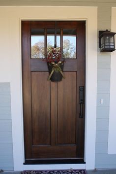 the front door is decorated with wreaths and decorations