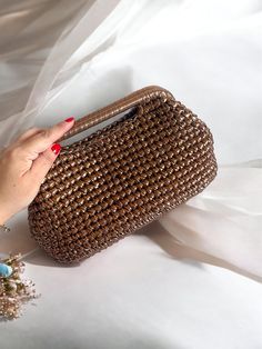 "Timeless and high quality handmade crochet knitted product  ✅A stylish women's accessory for daily use, special occasions, invitations, evenings! Wedding Party season  has begun and this bag will be the perfect choice 🤩 you will shine like a star All eyes will be on you this season with our trendy Metallic clutch lined with luxuriously matching Satin, metallic vegan leather and rich jewel tone colours, and you can be sure that these jewels will stand out in the crowd. Whether it's a night out, Handmade Brown Handheld Evening Bag, Brown Handheld Handmade Evening Bag, Elegant Hand Knitted Rectangular Shoulder Bag, Elegant Brown Crochet Bag With Braided Handles, Elegant Brown Crochet Bag For Daily Use, Elegant Rectangular Crochet Bag, Elegant Hand Knitted Rectangular Crochet Bag, Elegant Handwoven Brown Crochet Bag, Elegant Brown Crochet Shoulder Bag