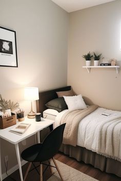 a small bedroom with a bed, desk and computer on the table in front of it