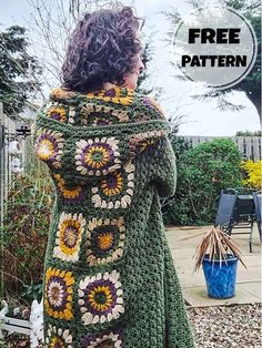 a woman wearing a green crocheted sweater with sunflowers on the back