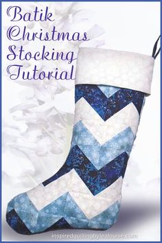 a blue and white christmas stocking with the words batik christmas pattern on it