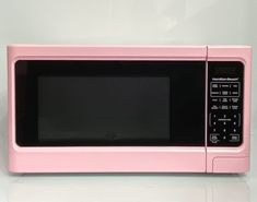 a pink microwave oven sitting on top of a counter