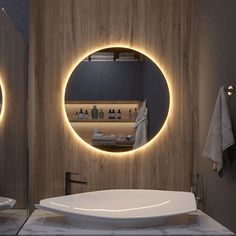 a bathroom with a round mirror above the sink