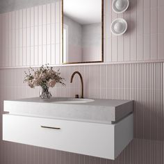 a bathroom sink sitting under a mirror next to a wall mounted faucet in front of a pink tiled wall