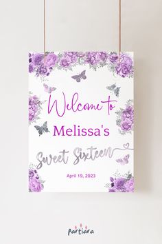 a welcome sign hanging from a string with purple flowers and butterflies on it, that says welcome to melissa's sweet sixteen