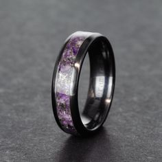 "This elegant ring is inlayed with crushed Amethyst crystals and meteorite shavings! A perfect gift for an Aquarius since it features their birthstone! Black Ceramic is a great choice for a ring because it is incredibly hard, so hard that it takes a diamond to scratch it! The material is also black all the way through, which is much better than most tungsten coated rings because the coloring will never come off! Engraving Available Here: https://www.etsy.com/listing/732624808 Crafted personally Amethyst Wedding Rings For Men, Amethyst Mens Ring, Mens Amethyst Ring, Black Amethyst Gemstone Ring, Black Mens Ring, Raw Amethyst Ring, Amethyst Wedding Rings, Promise Rings For Guys, Raw Crystal Ring