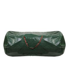 a large green bag sitting on top of a white wall next to a red handle