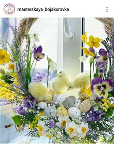 an easter wreath with flowers, eggs and chicks