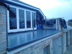 an image of a house that is being renovated with glass on the windows and roof