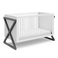 a white crib with an x design on the front and bottom part, against a white background