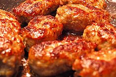 meatballs are being cooked in a frying pan