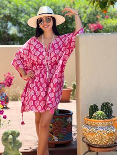 Merriam-Webster defines fanfare as a “showy, outward display.” In fact, our Fanfare Short Kaftan Dress is the perfect shade of pink to ready you for a showy, outward, display of fun and frolic. This beautiful print is made using the age old Dabu printing process. The Fanfare is block printed by hand with mud onto white fabric which is then dyed pink. The mud resists the dye and after being thoroughly washed, the fanfare design is left intact in white with a crackled effect that makes each piece Pink Printed Beachwear Dress, Pink Printed Short Sleeve Kaftan, Pink Short-sleeved Kaftan For Summer, Pink Short Sleeve Beachwear Kaftan, Pink Short Sleeve Kaftan For Beachwear, Pink Short Sleeve Kaftan For Summer, Pink Printed Tunic Dress, Pink Short Sleeve Kaftan For Spring, Pink Summer Tunic Dress