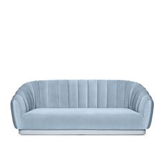 a light blue velvet sofa with an open back and pleated upholstered design