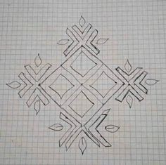 a drawing of an intricate design on a piece of paper with graph paper in the background