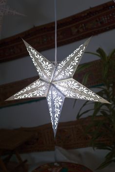 an origami star hanging from a ceiling