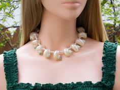 This elegant short choker necklace are made of pearlized turbo shells and freshwater pearl beads. Gorgeous and unique! Great idea for gift! 🎁 Necklaces - Length : approximately 14 1/2" long, strung with professional quality "Accu-Flex" 49 strands softest drape beading wire. Finished with 18k real gold plated toggle clasp. - Beads : approximately 20mm to 25mm white turbo shell and 5mm freshwater pearl. - These are made of natural organic real seashells, blemishes or imperfections are part of its Elegant Mother Of Pearl Shell, Elegant Pearl Charm Shell Necklace, Pearl Shell Necklace For Wedding, Pearl White Shell Necklace For Wedding, Elegant Shell Pearl Necklace With Pearl Charm, Elegant Pearl Necklace With Shell And Pearl Charm, Wedding Pearl Necklace With Shell Shape, Elegant Pearl White Shell Necklace, Pearl Chain Shell Necklace