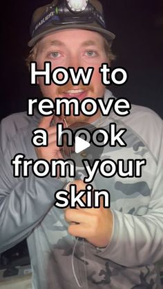 a man holding a cell phone to his ear with the words how to remove a hook from your skin