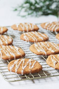 cookies with white icing sitting on a cooling rack