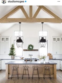 an open kitchen with white cabinets and wooden beams on the ceiling is featured in this instagram