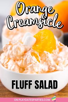 orange creamsice fluff salad in a white bowl with an orange on top