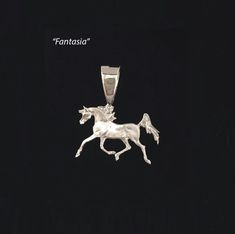 a silver horse pendant on a black background with the words tantassia above it