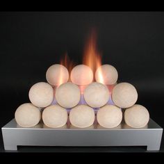 a white fire place sitting on top of a metal stand with flames coming out of it