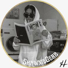 a woman in a hooded sweatshirt reading a book