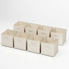 six white storage bins with handles on each side and one in the middle, all lined up