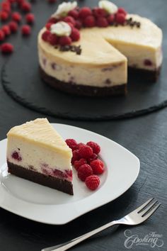 two slices of cheesecake with raspberries on a plate