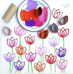 an art project with flowers and toilet paper rolls