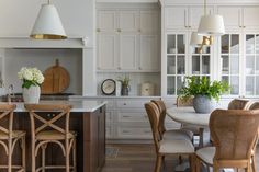 the kitchen is clean and ready for us to eat in it's white cabinetry